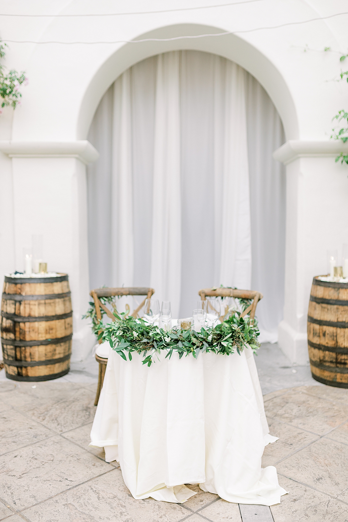 The couple's sweetheart table centered between two wine barrels.