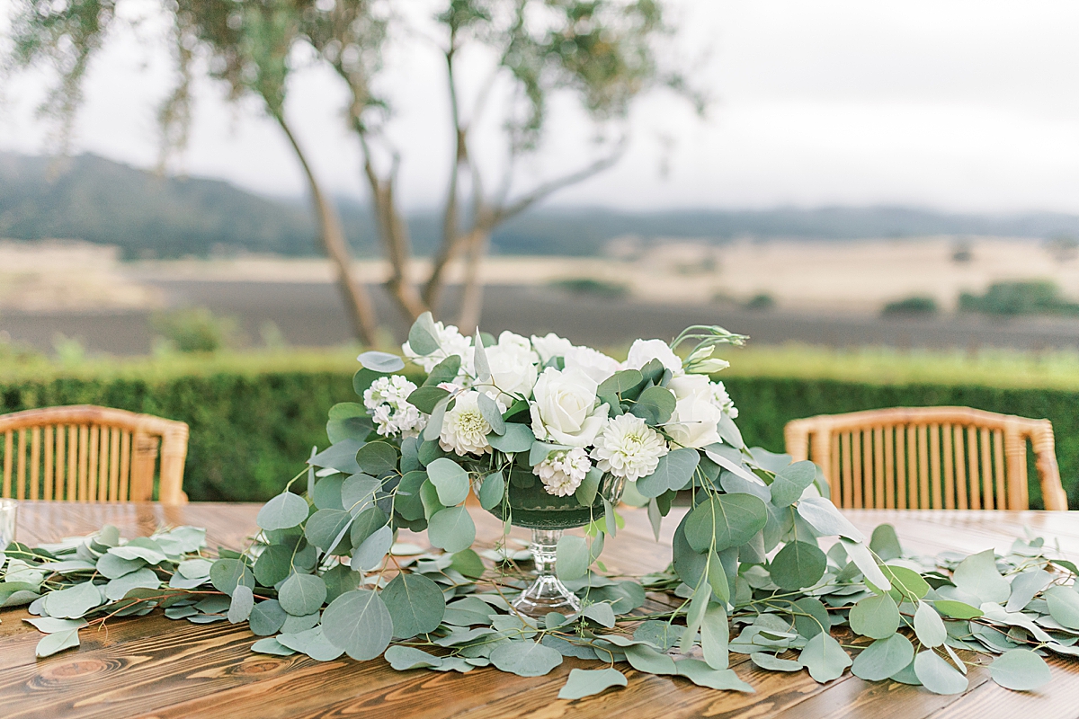 A floral centerpiece on one of the tables at the couple's during their San Luis Obispo Mission wedding reception venue.