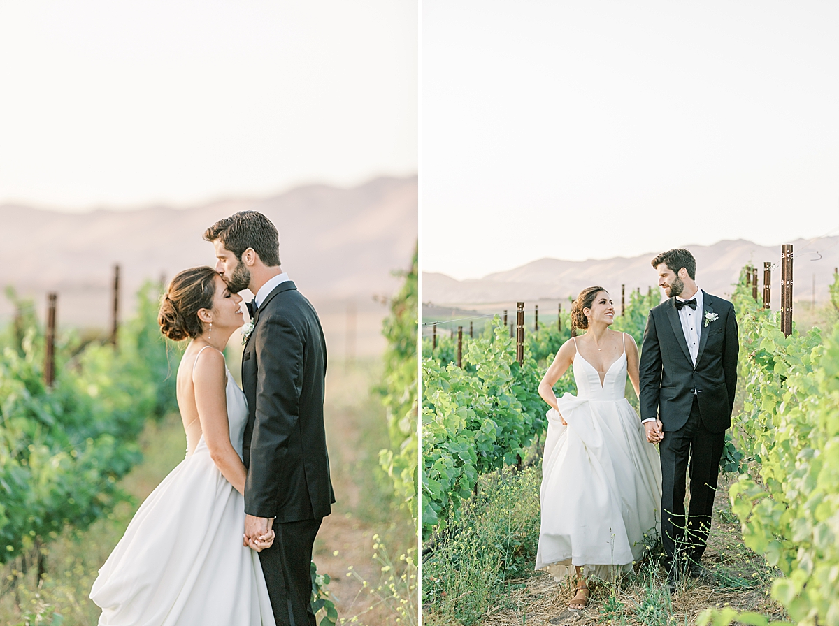 Brett kissing his bride on the forehead as they hold hands. A second image of the couple walking through the vineyard towards the camera during their San Luis Obispo Mission wedding.