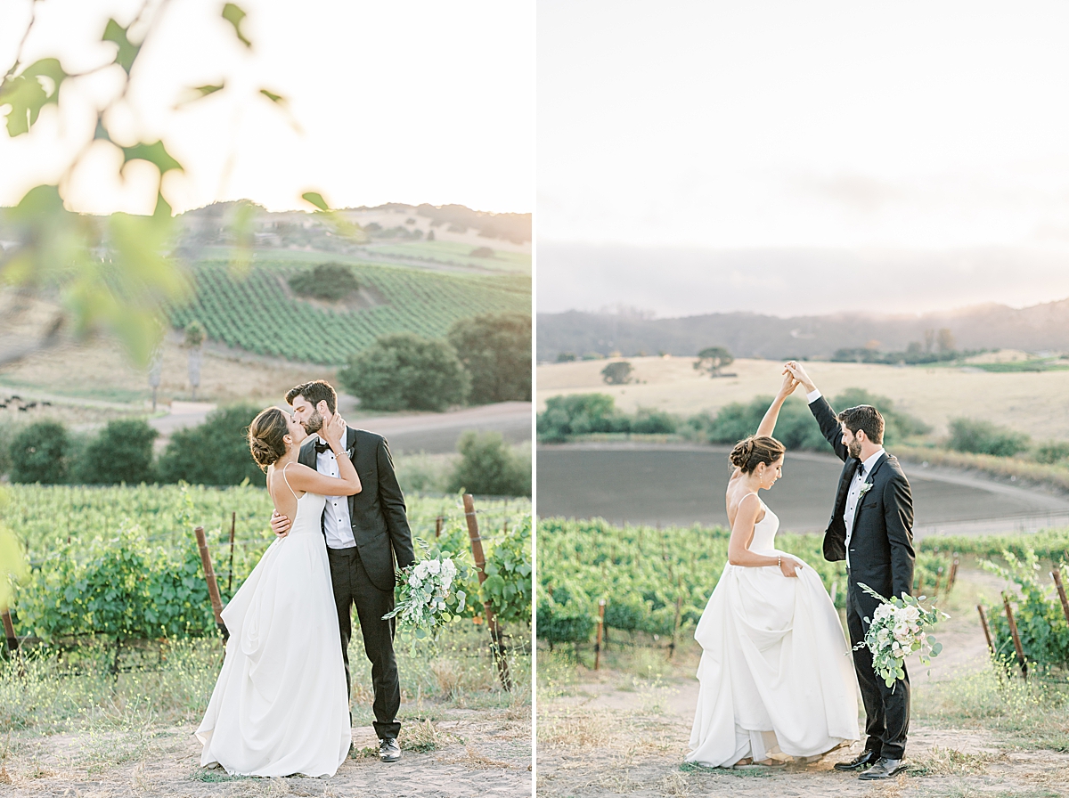 The couple sharing a dance in front of the vineyards and mountains at their San Luis Obispo Mission wedding.