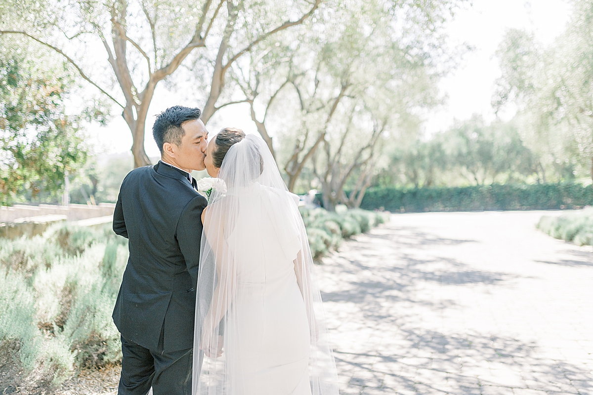 Erica & Gideon sharing a kiss at the San Ysidro Ranch after their Montecito Church Wedding.