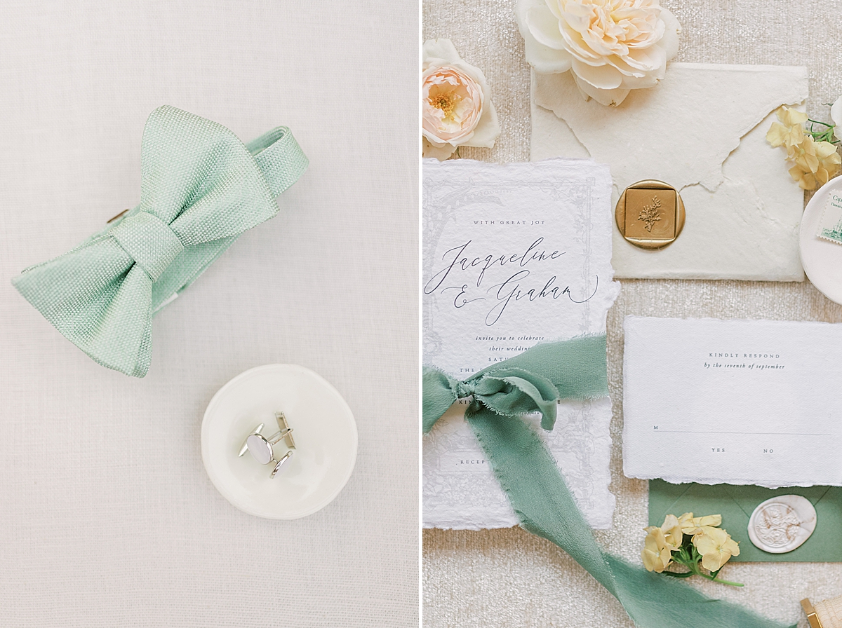 a bowtie and cufflinks next to an invitation suite