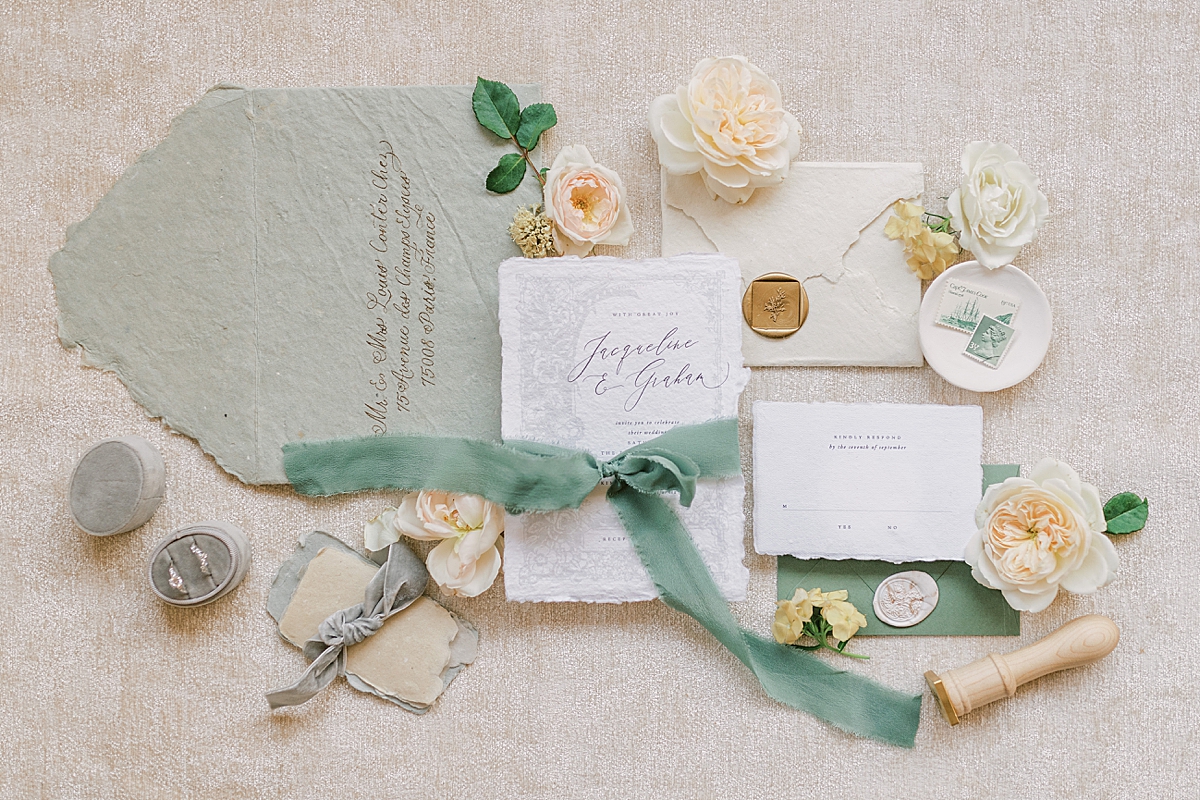 An invitation suite complete with rings and a wax seal stamp.