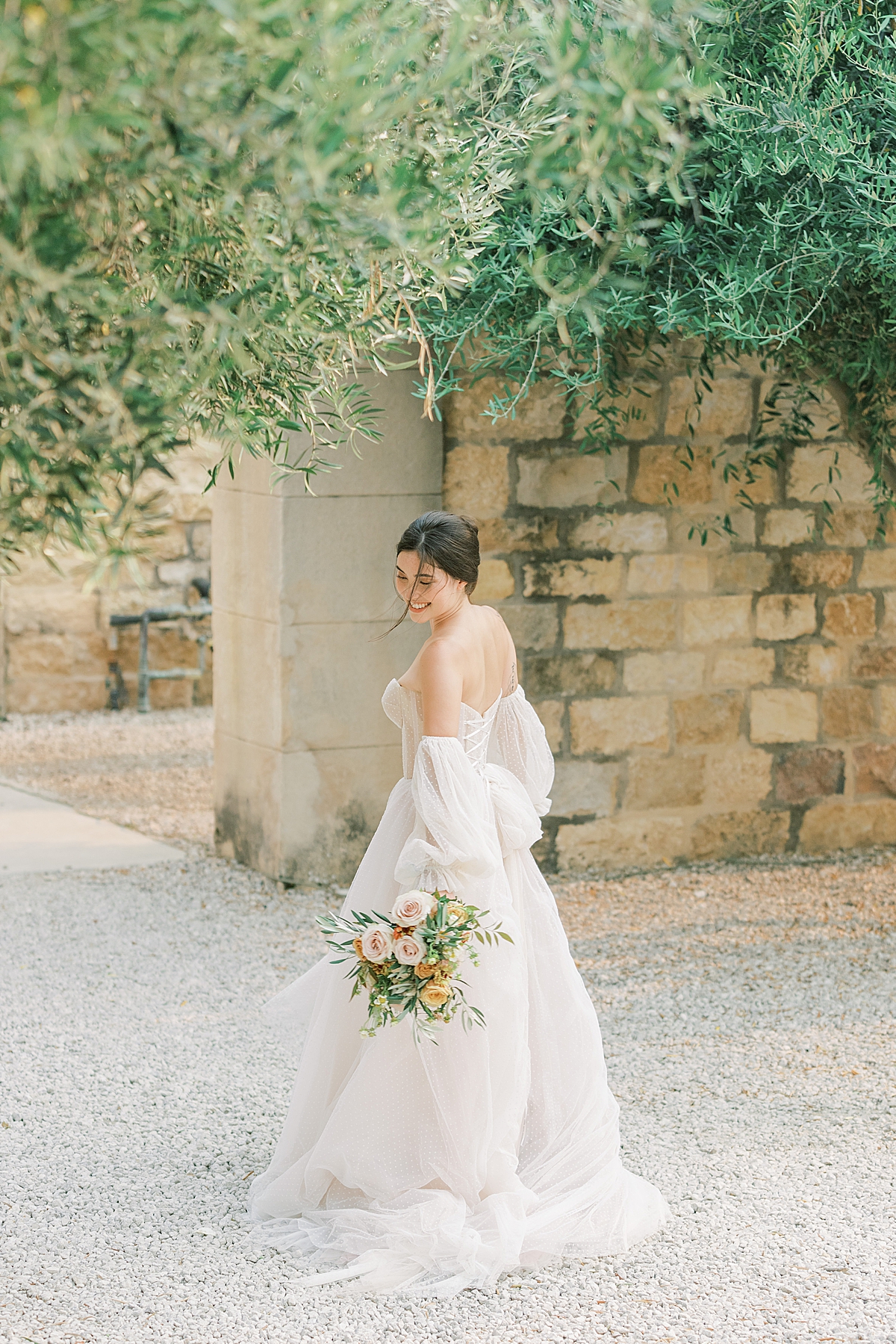 The bride holding all the layers of her dress at this Sunstone Villa Wedding editorial.