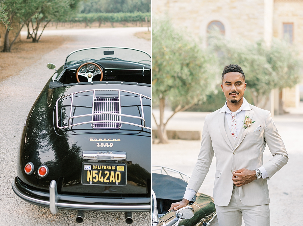 The groom holding onto the edge of the door of the vintage car.