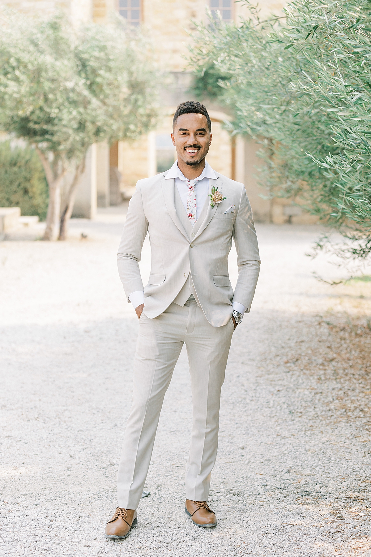 The groom smiling for a portrait at this Sunstone Villa Wedding editorial.