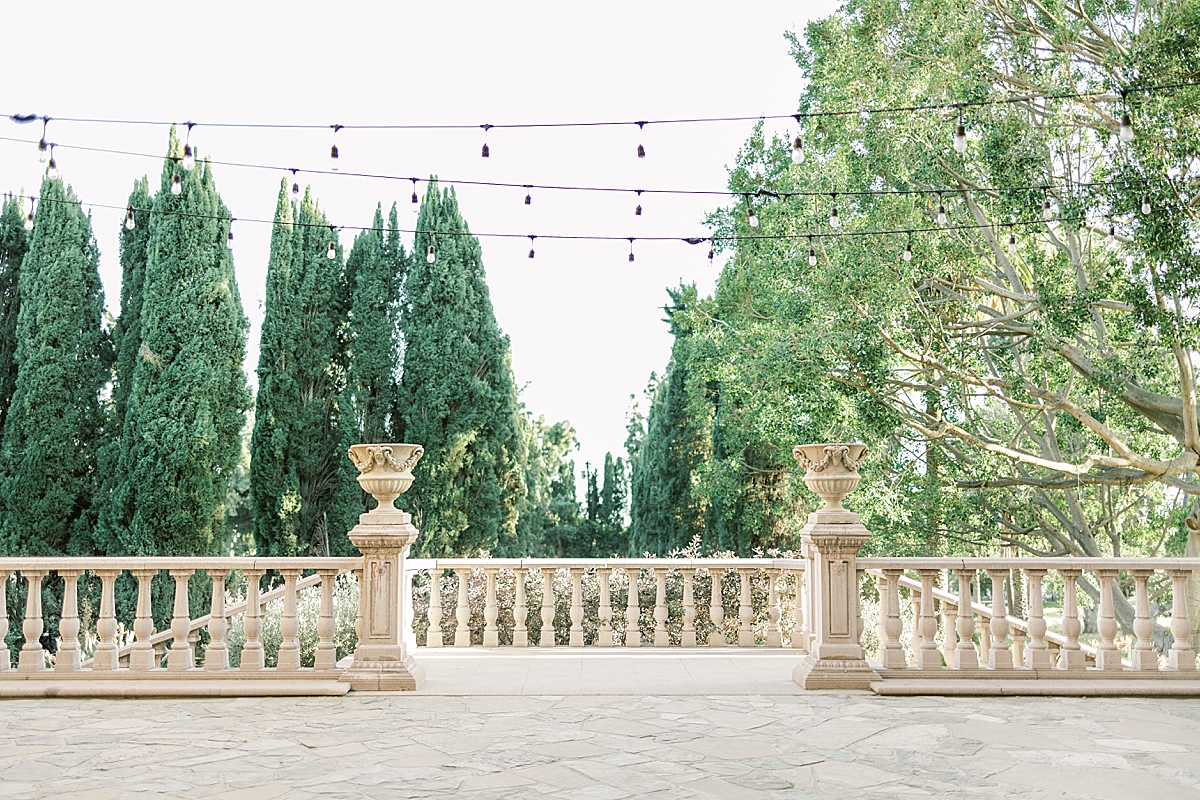 A view of the courtyard and decorative balcony that overlooks the ceremony space below at the Villa del Sol d'Oro