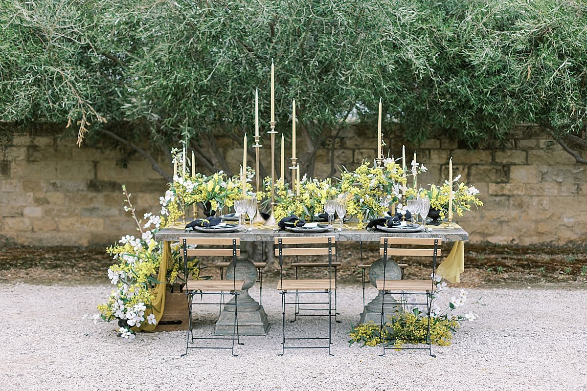 An intimate reception dinner covered with multiple heights of candles and florals. 