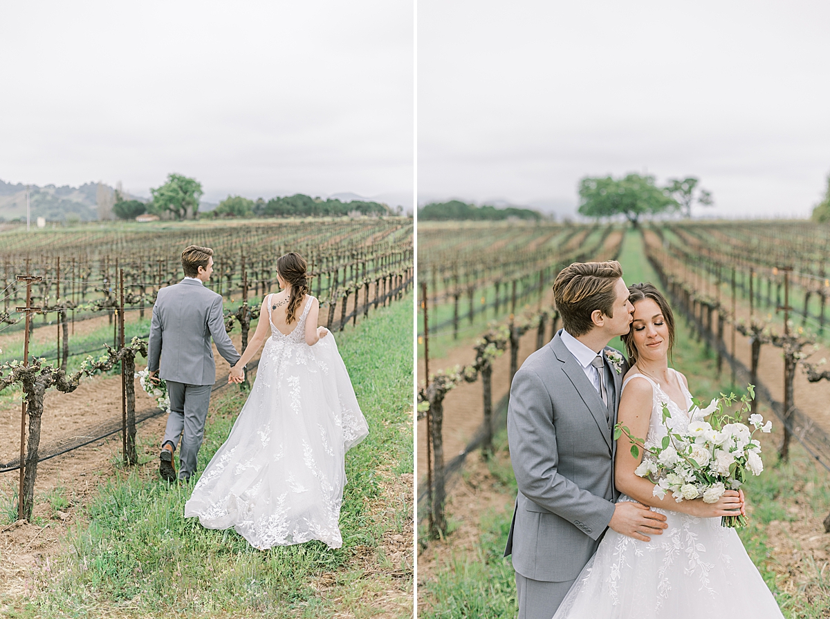 The couple holding hands as they walk through the vineyards. A second image of the groom giving his bride a kiss on the cheek as she leans up against him.