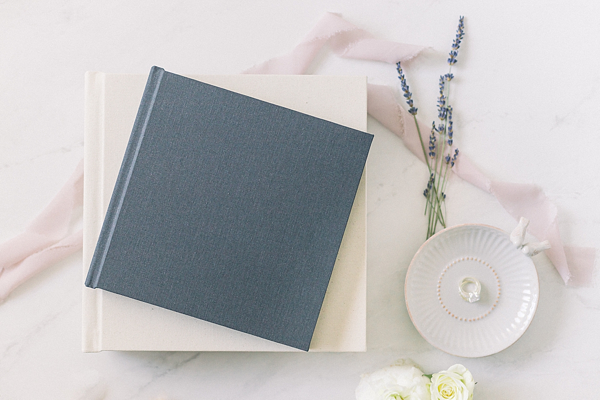 An image of two wedding albums with some lavender and ribbon.