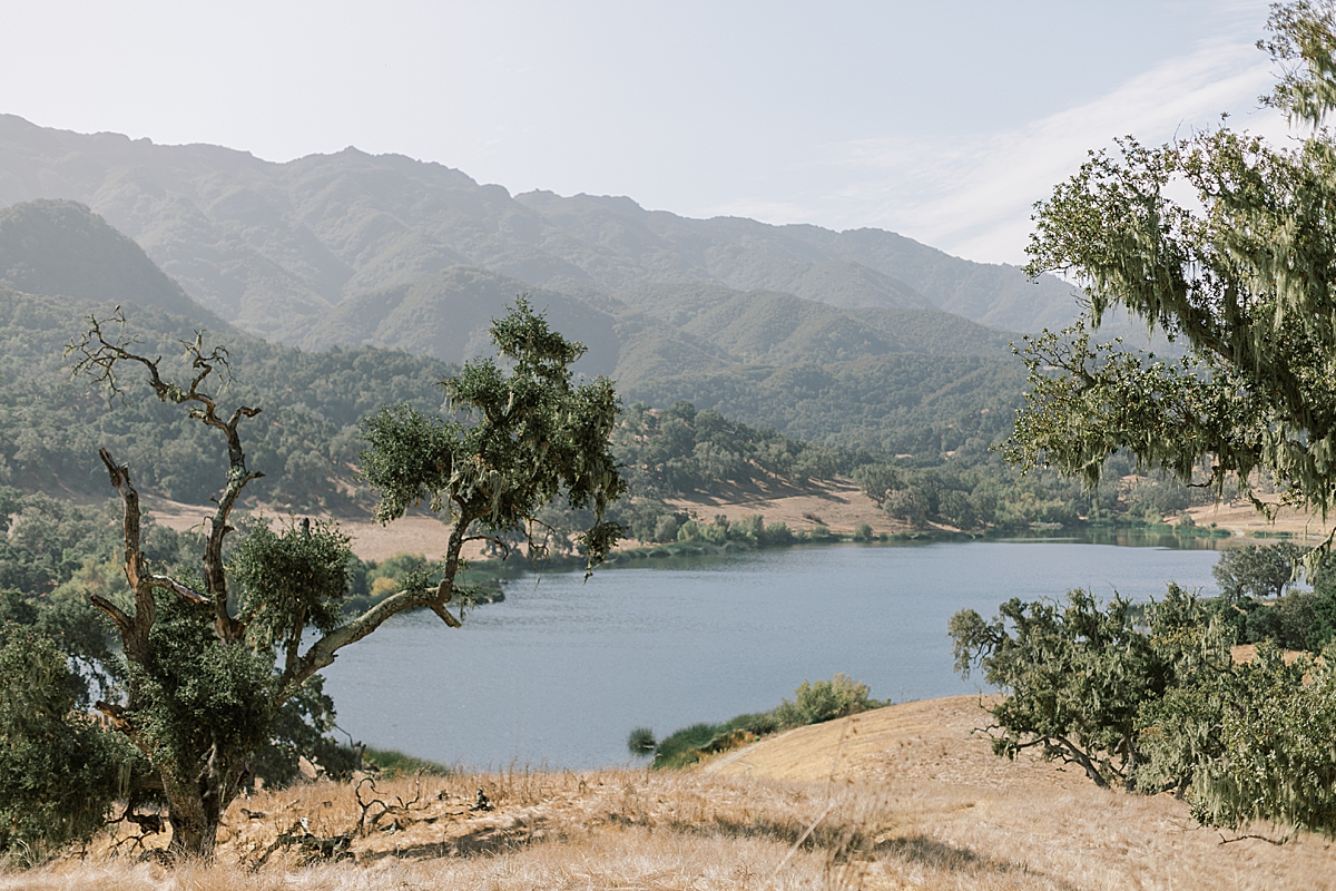 Views of the private lake and surrounding mountain ranges in the distance at Alisal Ranch in Solvang, California.